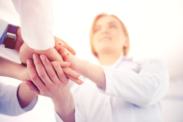Medical doctors shaking hands, bottom view. Medical and healthcare concept