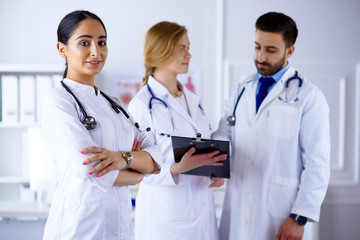 Attractive female arab doctor in front of medical stuff