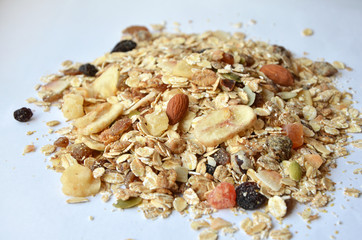 granola with fruits and nuts on a white background