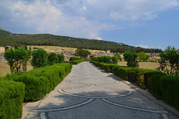 Old Hierapolis ruins, amphitheatre and touristic locations captured with hill background, in daytime.