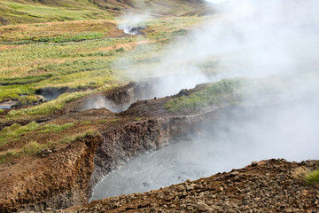 Hot Spring Hiking and Natural Bathing in Geothermal Hot River Reykjadulur, Iceland, Europe.