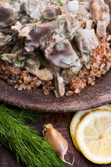 Stewed turkey stomachs with vegetables and buckwheat in a bowl