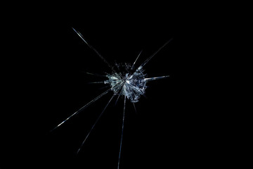 crack on the glass mirror in the form of abstraction on a black background