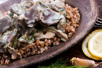 Stewed turkey stomachs with vegetables and buckwheat in a bowl