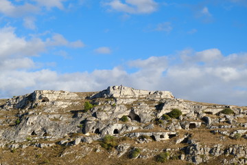 Fototapeta na wymiar Mountain in front of the city of Matera in Italy. Caves used as dwellings in prehistoric times