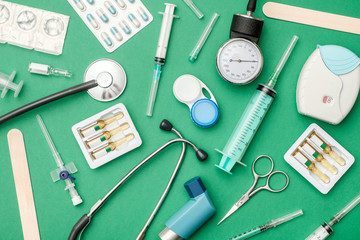 Flat lay of medical tools on colored background