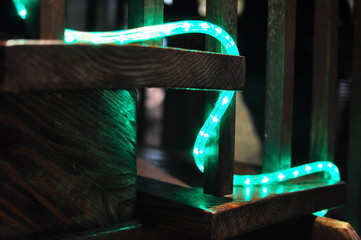 Neon rope light snakes its way up an old wooden stairway