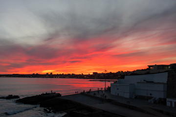 Fototapeta na wymiar Fire sunset over ocean seaside in Estoril, Portugal