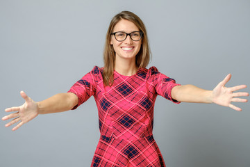 Woman smiling with open arms for hug - obrazy, fototapety, plakaty