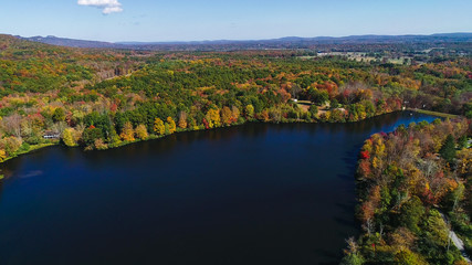 Fototapeta na wymiar Aerial drone view of lake in autumn state park.