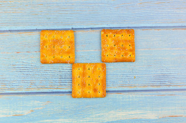 Sugar crackers on wooden background.