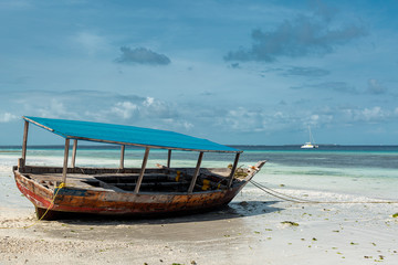 Naklejka na ściany i meble Empty boat on a beach
