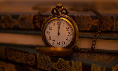 Vintage Antique clock placed with Arabic books in background