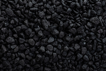 Black road stones gravel texture. Rocks for construction, dark background of crushed granite gravel, small rocks, wallpaper