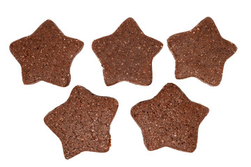 Top view on five delicious homemade chocolate and sugar cookies in the shape of stars isolated on a white background. Christmas or holiday baking for the whole family