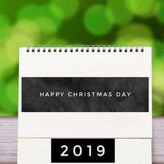 December 25 2019 calendar Christmas day. old wood table, green nature background, 25 december text, countdown to holiday season, merry christmas, happy new year 2019 concept.