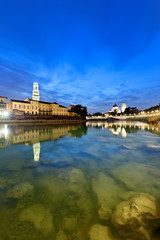 The river Adige flows in the city center of Verona. On background the Santa Maria Matricolare Cathedral and the San Giorgio in Braida Church. Verona, Veneto, Italy, Europe.