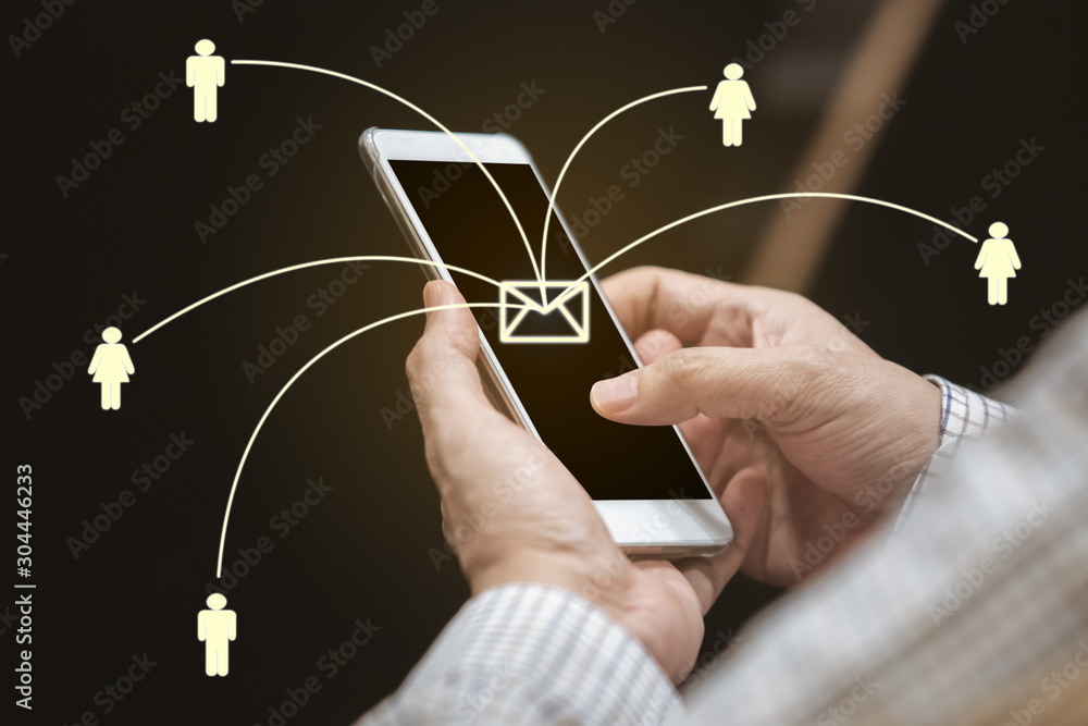 Wall mural close up hand of man using smartphone sending message from e-mail to other people with network. cont