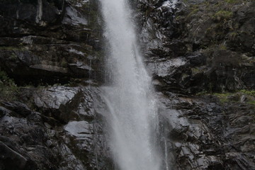 high waterfall near a lake