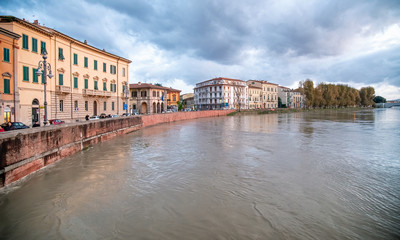 Swollen River Arno in Pisa at sunset, Bad Weather on Tuscany, Italy