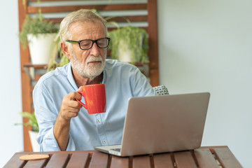 Portrait senior man using laptop for working at home, Freelance concept - Image