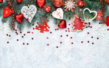 Christmas decoration collection: hearts, branches and bauble decor on stone background. Xmas backdrop for your greeting card with space for text