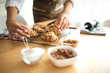 Young woman in the kitchen serves baked cookies