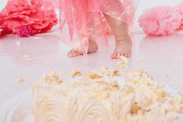 The baby's leg was covered in food close up. birthday party