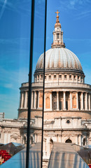 Fototapeta na wymiar London St Paul Cathedral Dome with reflection on a modern building