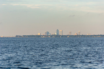 Fototapeta na wymiar View of the city of Jacksonville, Florida, from the distance, while sailing on the Saint John's river on a sunny afternoon. United States