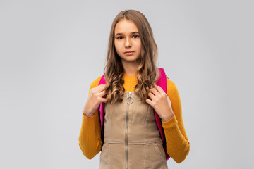 high school, education and people concept - smiling teenage student girl with backpack over grey background