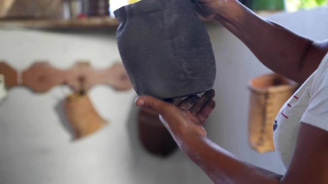 A woman makes pottery pieces