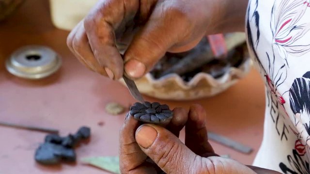 A woman makes pottery pieces