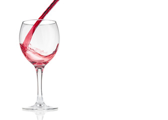 Red wine pouring  into glass on white background