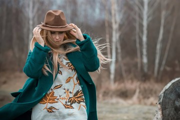 Woman of plus size, American or European appearance walks at the nature. A young lady with excess...