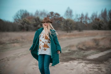 Woman of plus size, American or European appearance walks at the nature. A young lady with excess...