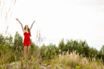 young woman in red dress nature fresh air