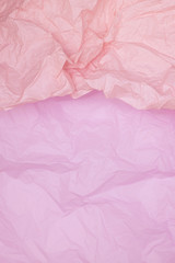 Fototapeta premium Two-tone pink crumpled paper texture, pink background, wallpaper, verticall