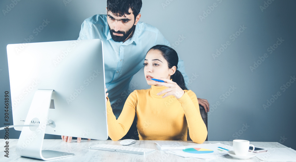 Poster team working in computer on gray background