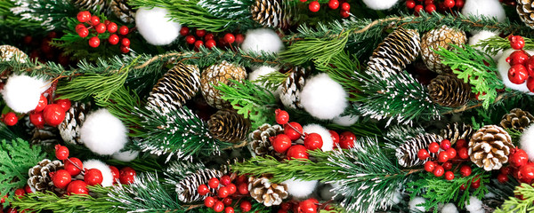 Beautiful Christmas decoration spruce, cones and red snow-covered berries, festive background, wallpaper, banner