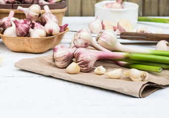 Raw Vegetables Fresh Harvest. Garlic Cloves and Garlic Bulb on a white wooden rustic table