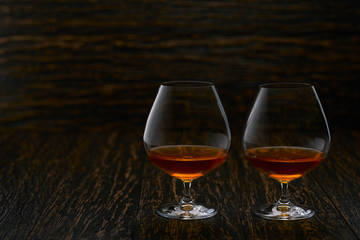 Cognac on a wooden table, selective focus with copy space.