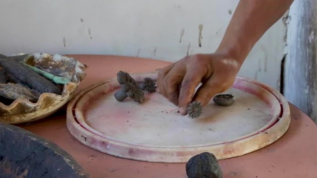 A woman makes pottery pieces