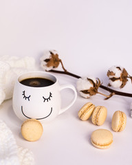 Cup of coffee and macaroons on white background.
