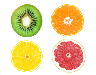 Colorful round slices, pieces of citrus fruits. Set, composition of ripe fresh fruits isolated on white background: green kiwi, yellow lemon, red grapefruit, orange. Healthy vegan or vegetarian food.