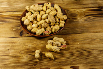 Peanuts in nutshell on a wooden table