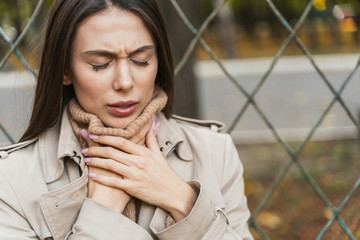 Portrait of brunette female that having sore throat