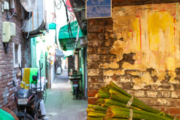 Obraz na płótnie Canvas Brick wall and narrow alley in defocus. Blurred Narrow alley at colorful Asian street. Asian shopping street.