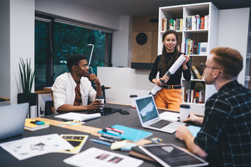 Talking diverse colleagues at table