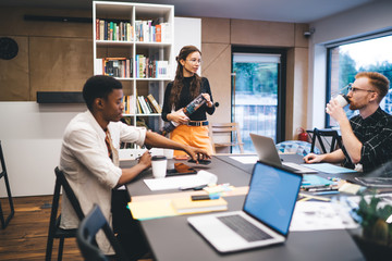 Contemporary diverse colleagues in trendy office